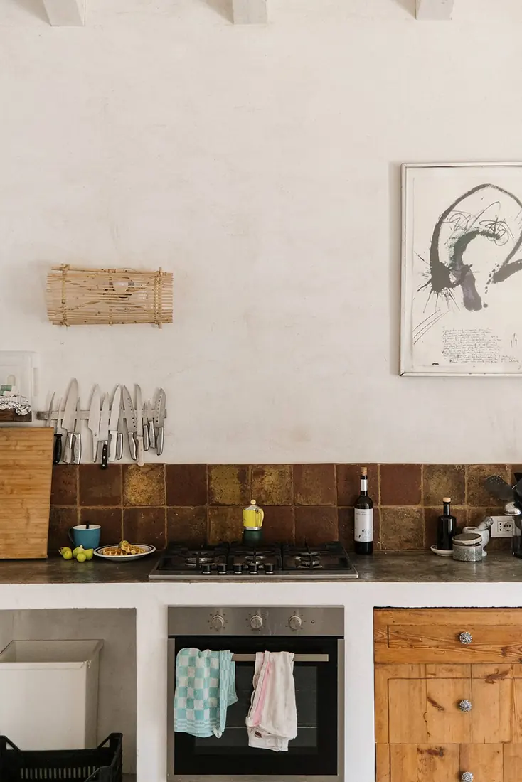 The corner of the kitchen with its gas hob, oven and tiled splashback