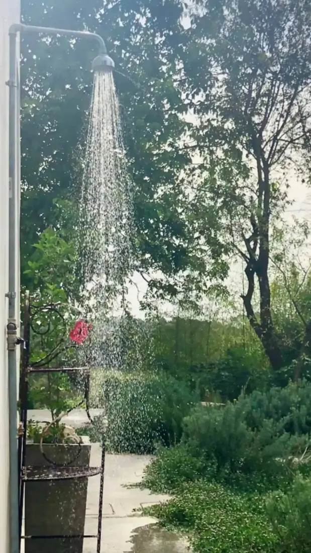 An outdoor shower open to the garden, connected to one of the rooms
