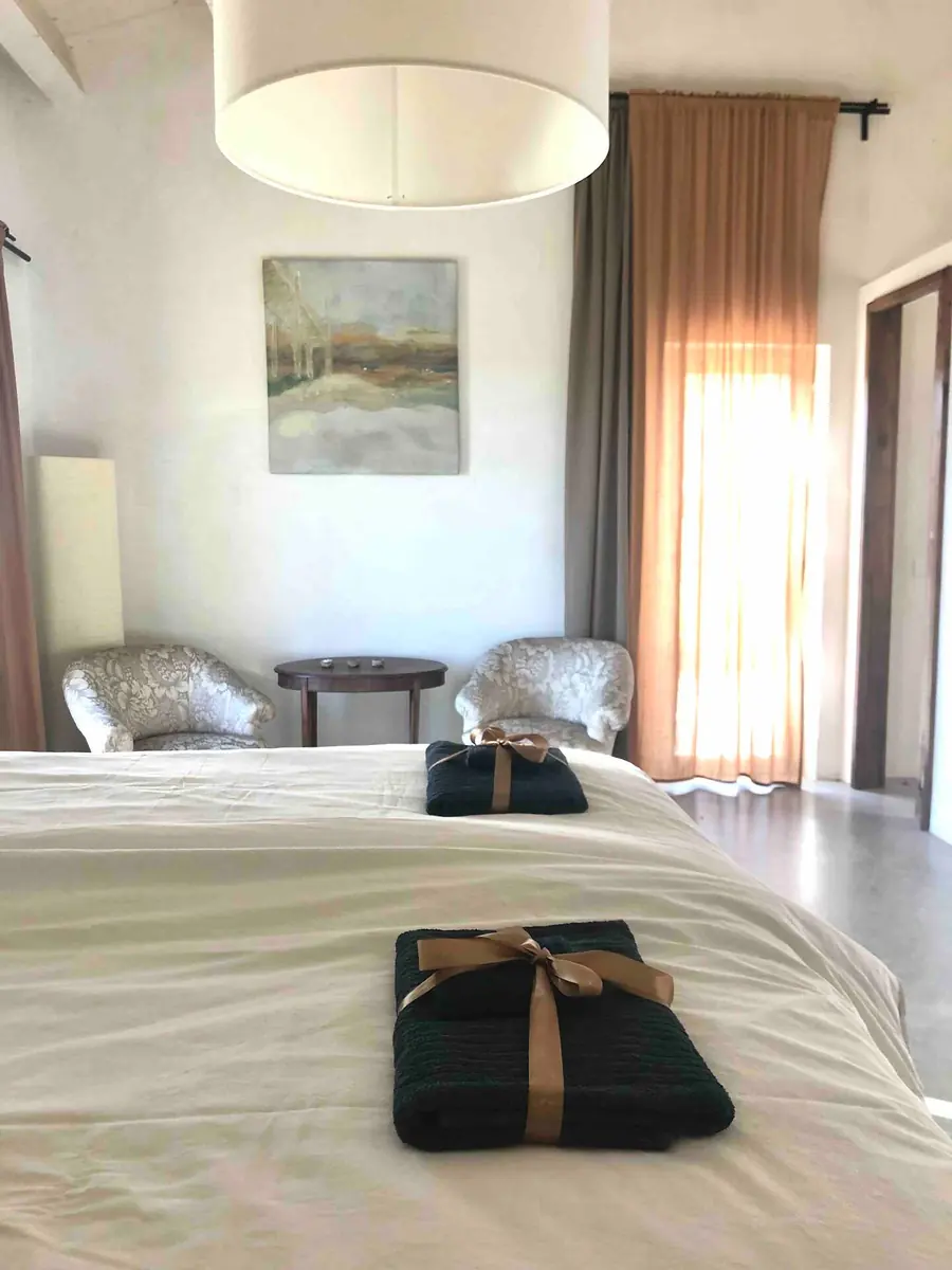 The bed in Room 1, made up with folded towels laid out for arriving guests